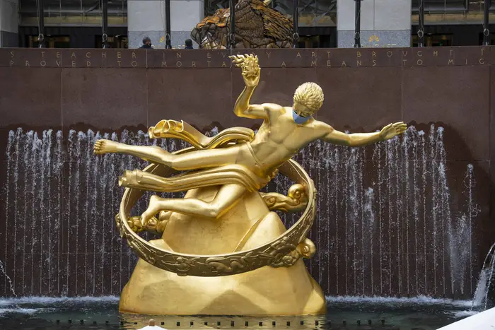 The Prometheus sculpture in Rockefeller Center features a PPE mask due to Covid-19 in Manhattan.